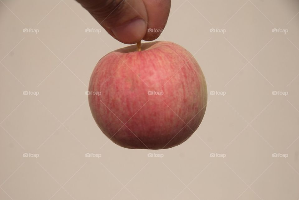 Apple hanging with white background