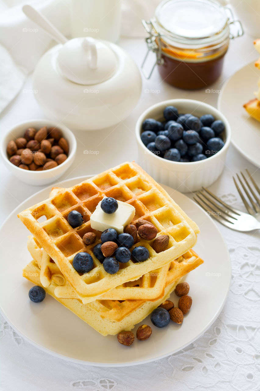 Belgian waffles with butter, blueberry and nuts