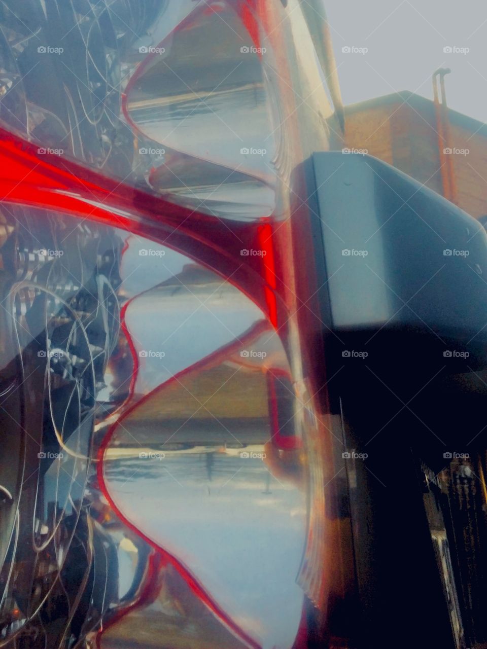 An interesting cubist collage spontaneously emerged when I took a picture of a stylish red sportscar at various angles through its rear view mirror. The photo was taken in the summer of 2019 in Long Island City, Queens. Hypnotic Productions 