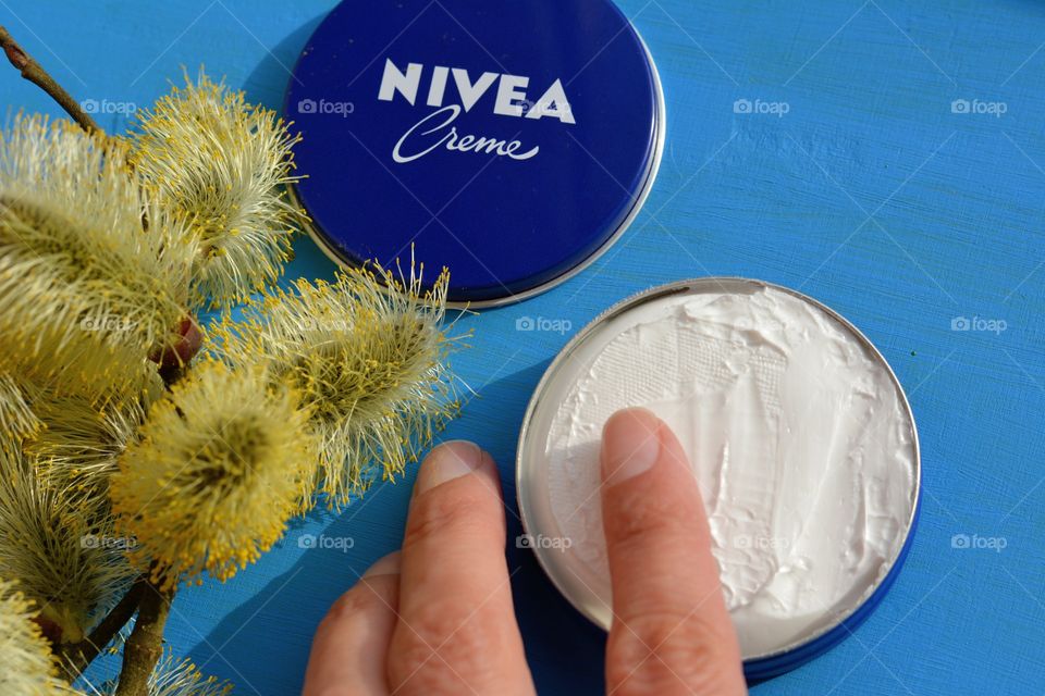 take care female hand and Nivea cream