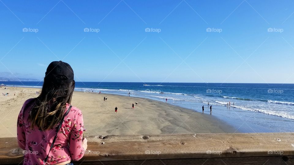 fashionable woman looking out the sea view of the ocean