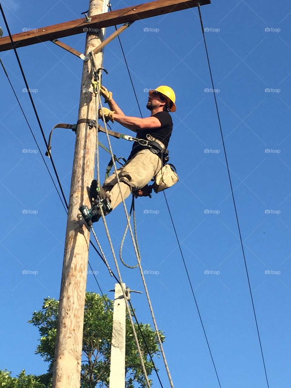 Lineman climbing pole in Haiti. 