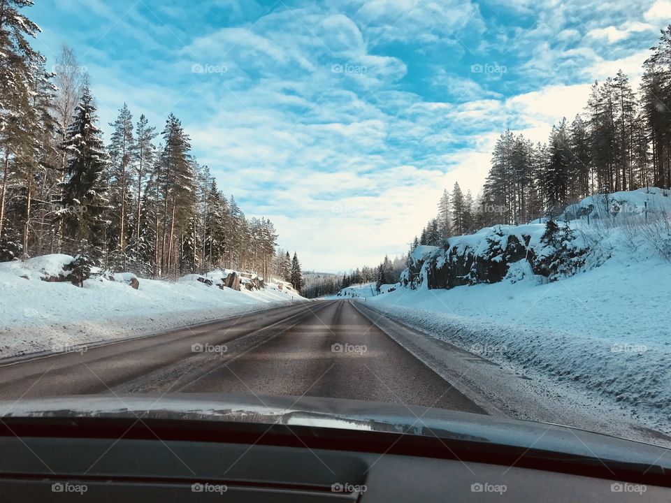 A view from a car to a snowy road