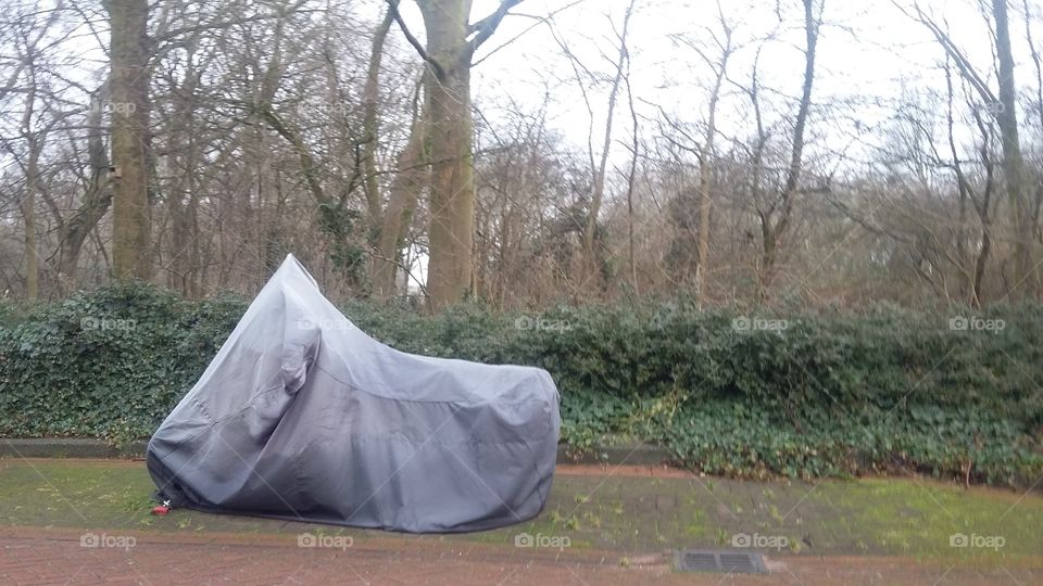a motorbike parked under sail