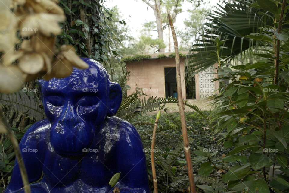 Blue monkey statue in a garden 