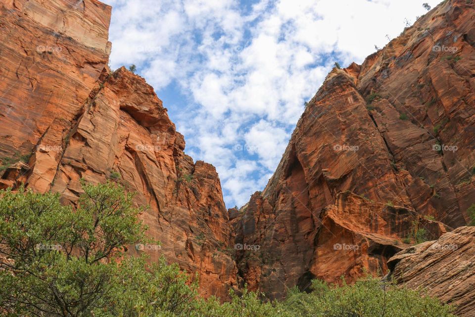 cotton like cloud in blue sky over the red hills