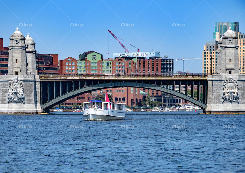 A ship going under the bridge in boston.