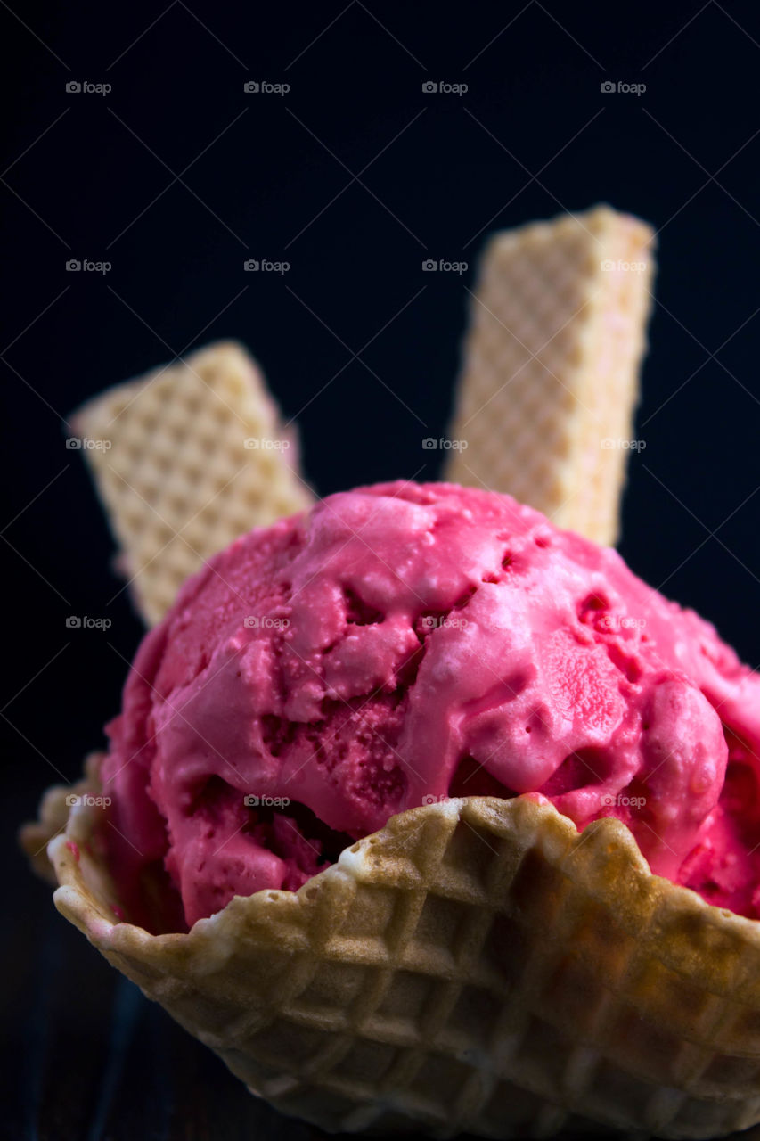 Raspberry ice cream with black background