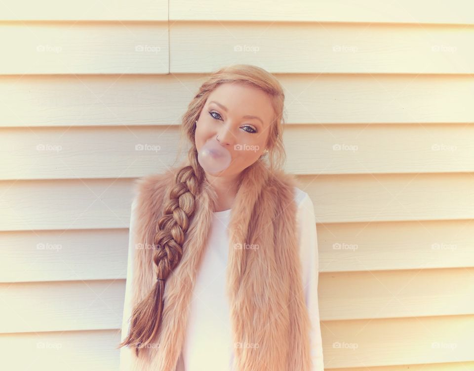 Woman blowing bubble with bubble gum