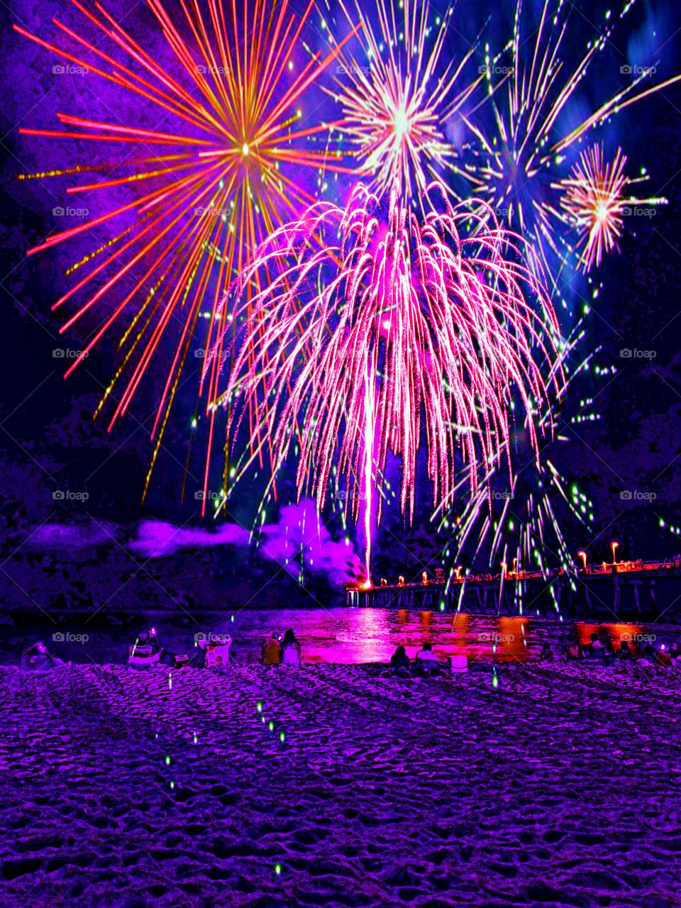 Color: Pink - Spectacular and colorful fireworks explode over the beach of the Gulf of Mexico leaving the spectators in awe. The colors reflect off the waters surface
