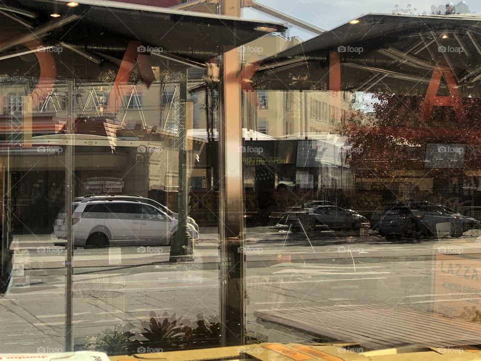 The reflection of Oakland’s buildings through the Whole Foods window in Oakland California 