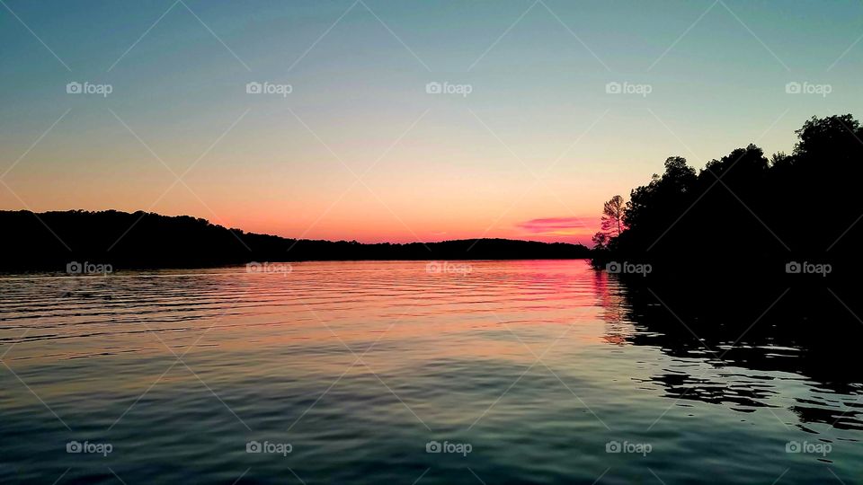 a pink sunset on the lake