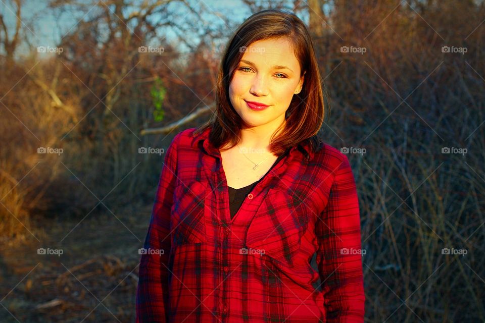 Country sunset. A girl in a flannel