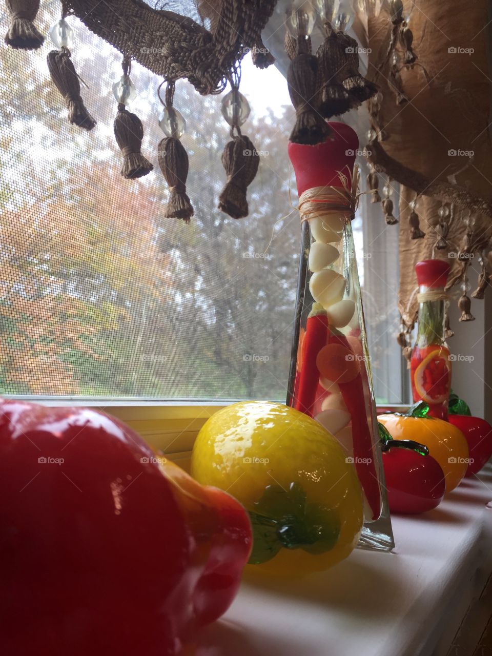 Kitchen window with bright colorful art glass vegetables 