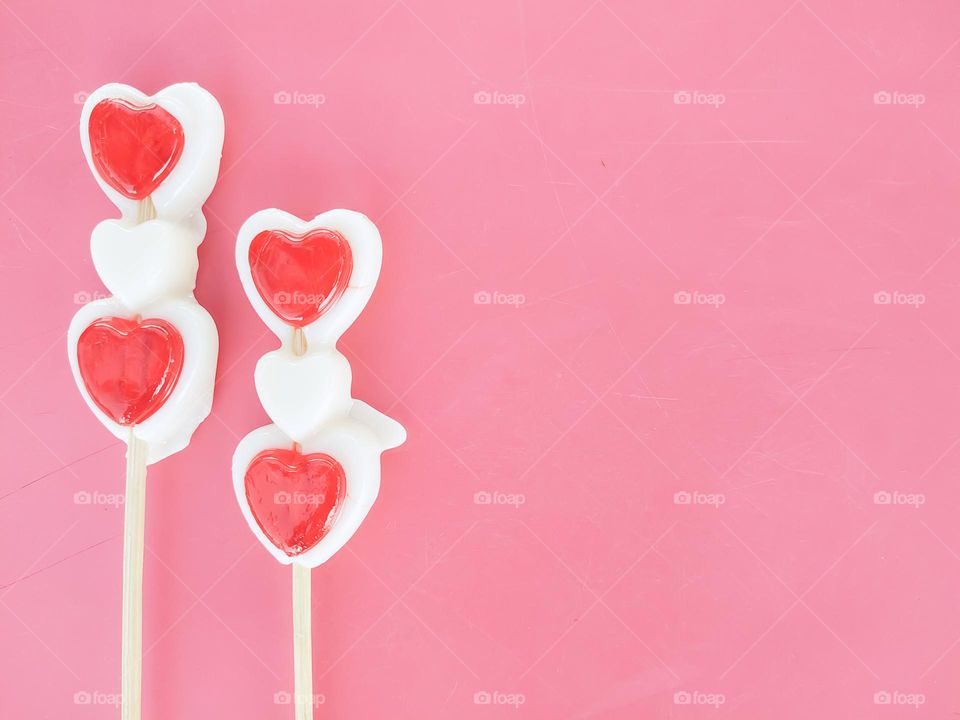Beautiful heart - lollipop candy for valentine's day celebration on pink background