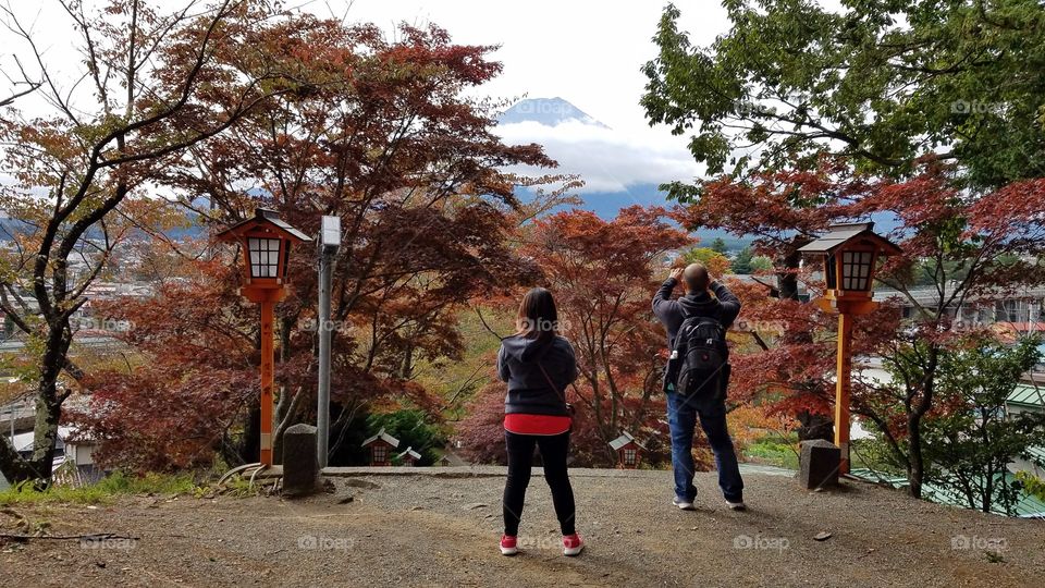 People taking pictures of Mount Fuji volcano