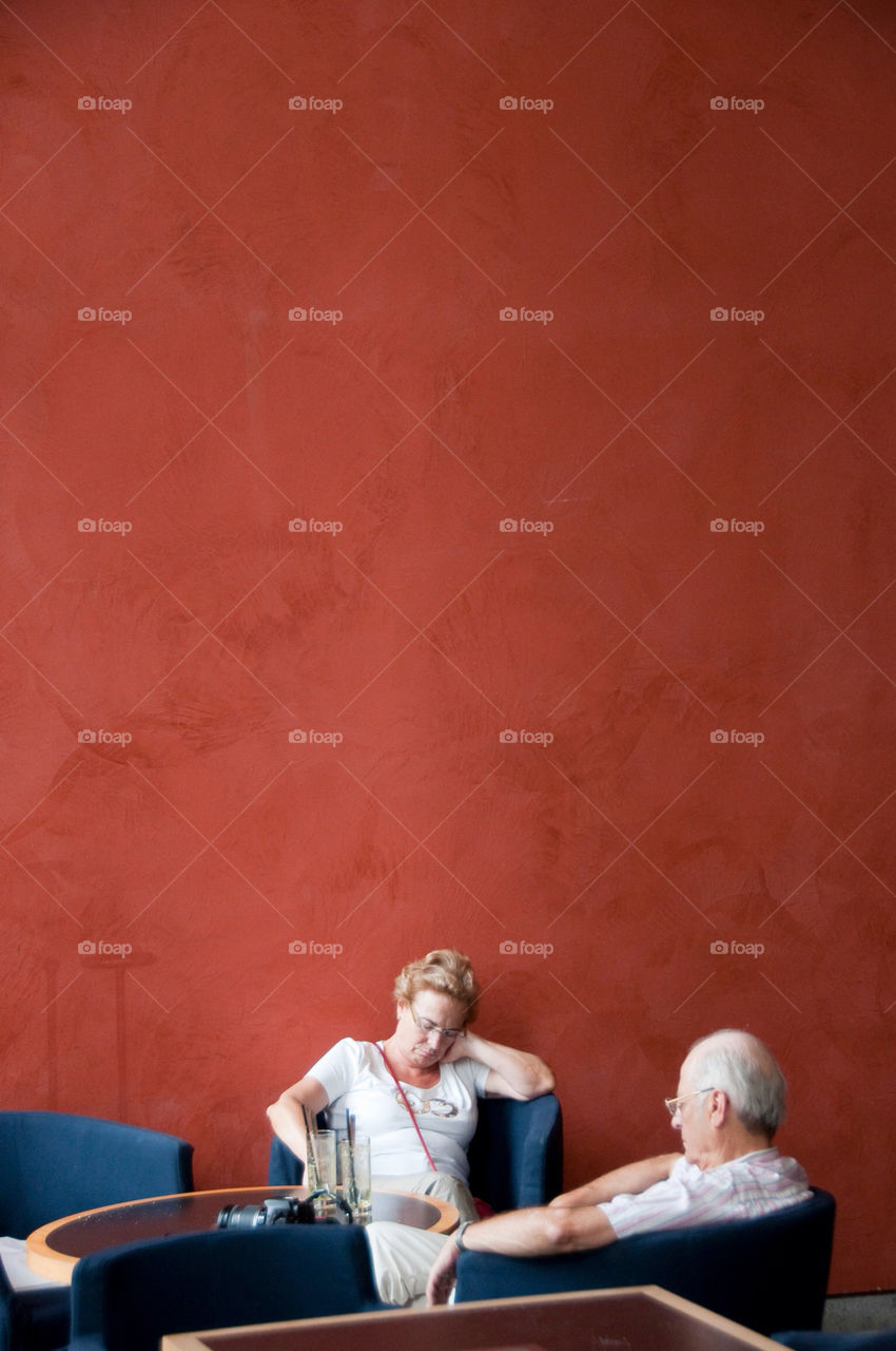 Man and woman take a nap in the lobby of the art museum