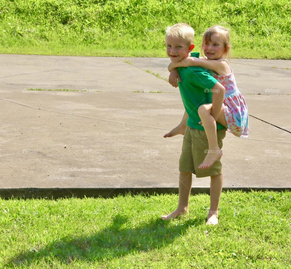 Brother and sister playing in the sun