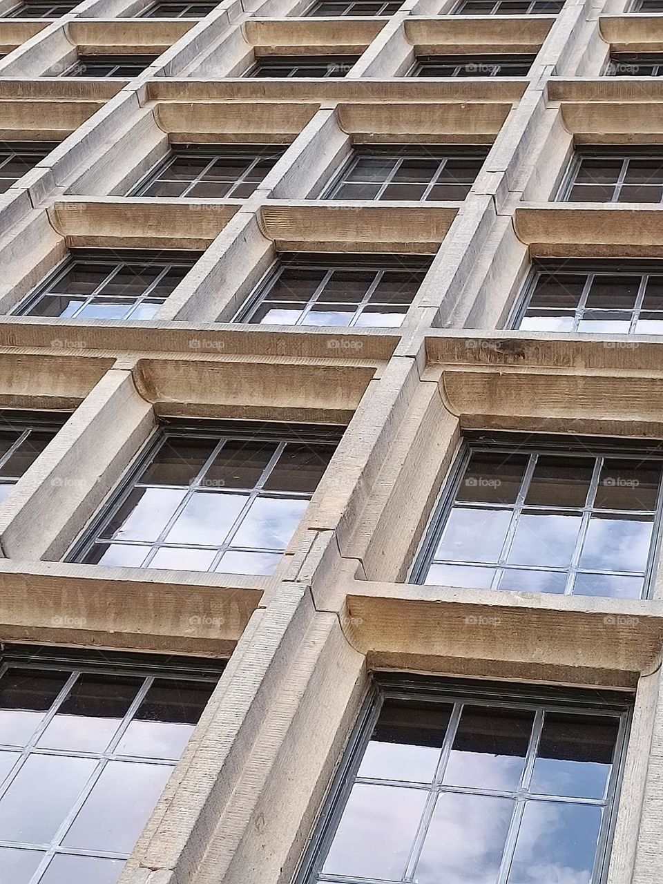 High angle view an close up of a front of windows with reflection of a cliudy sky