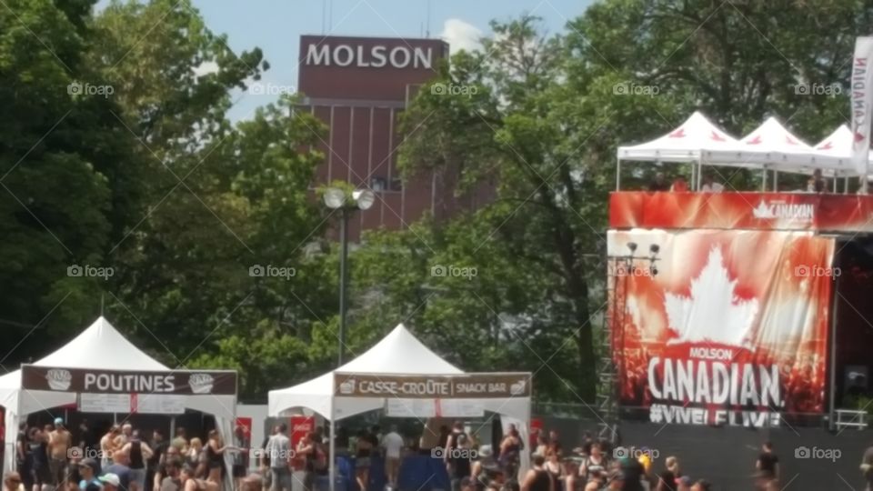 Molson Brewery in Montreal viewed from Heavy Montreal concert with poutine vendor in foreground