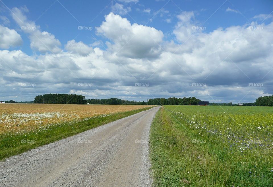 Empty road against cloudy sky