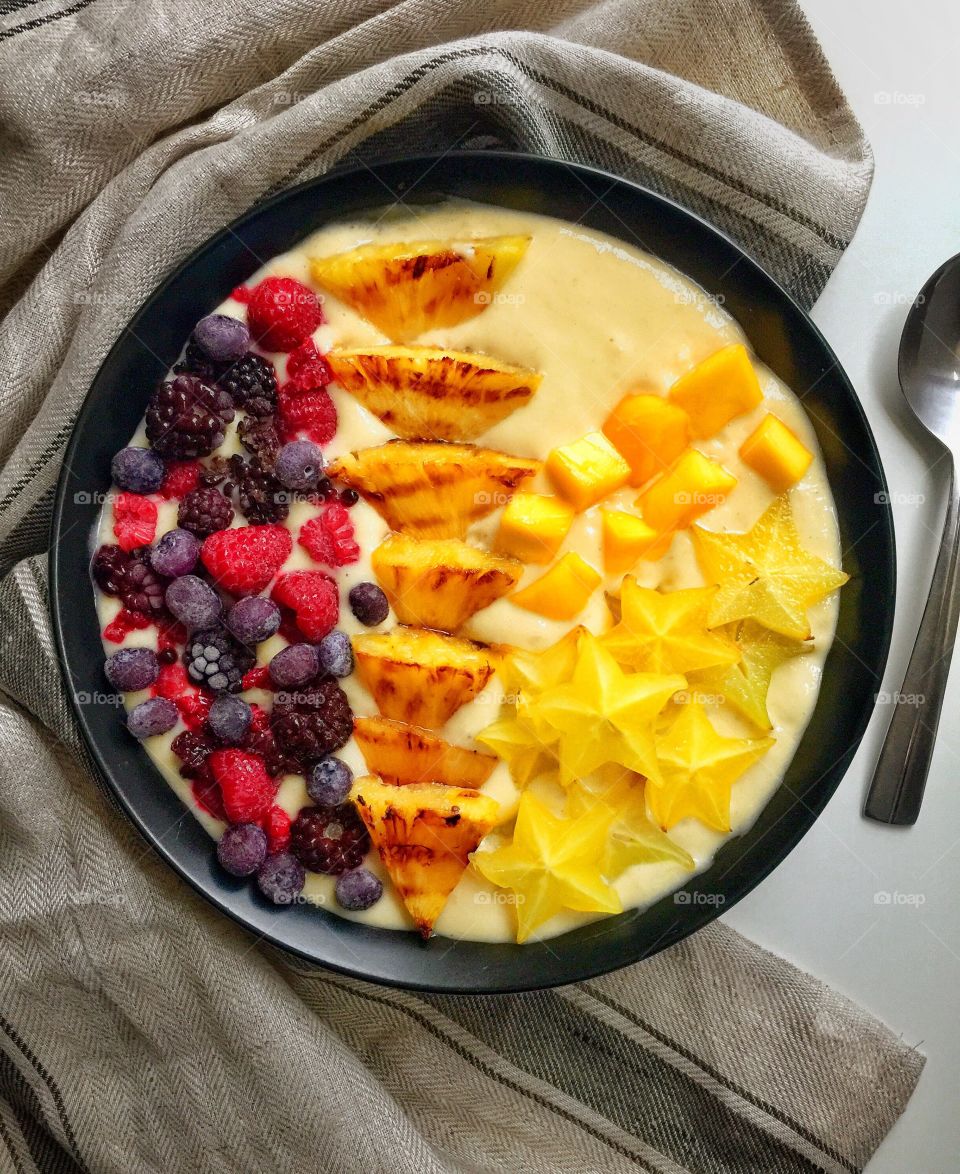 Grilled pineapple mango and berries smoothie bowl 