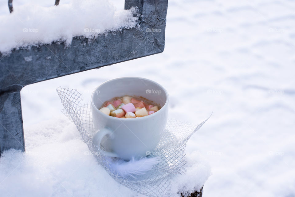 coffee with marshmallow on snow