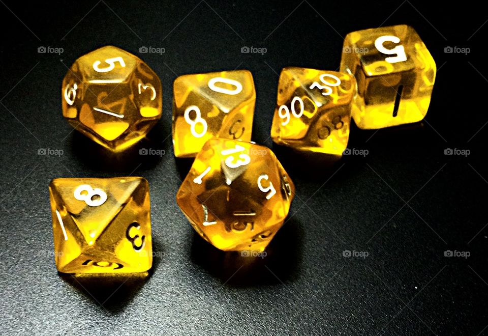 Throw the dice.. Yellow transparent  dungeons and dragons dice.