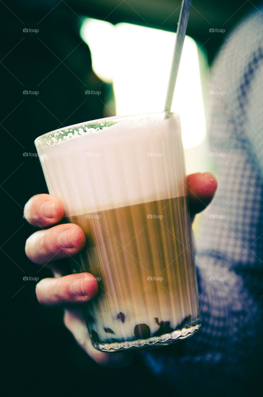 A person holding cup of coffee