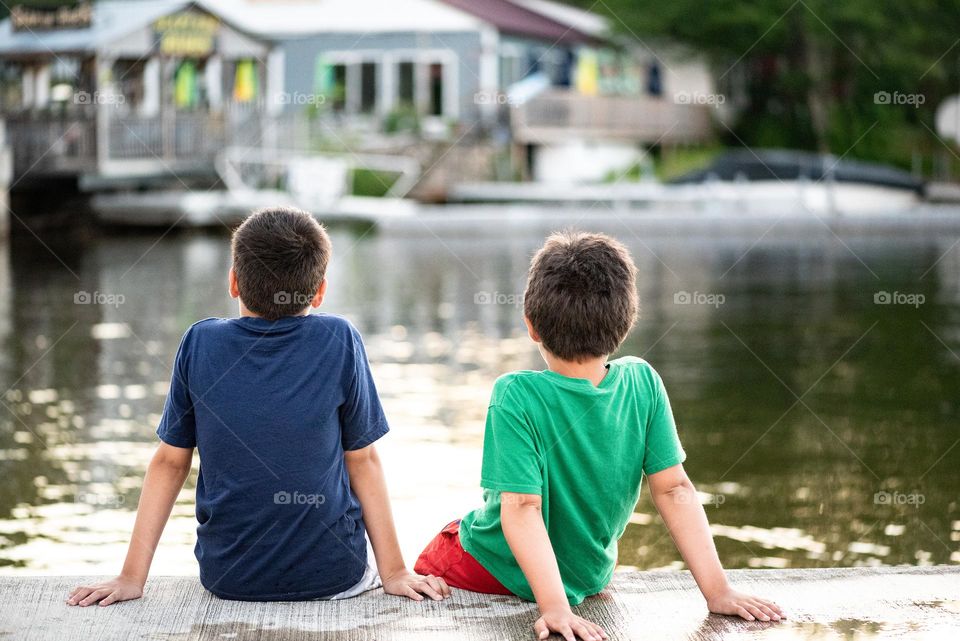 Little boys enjoying the summer lake view