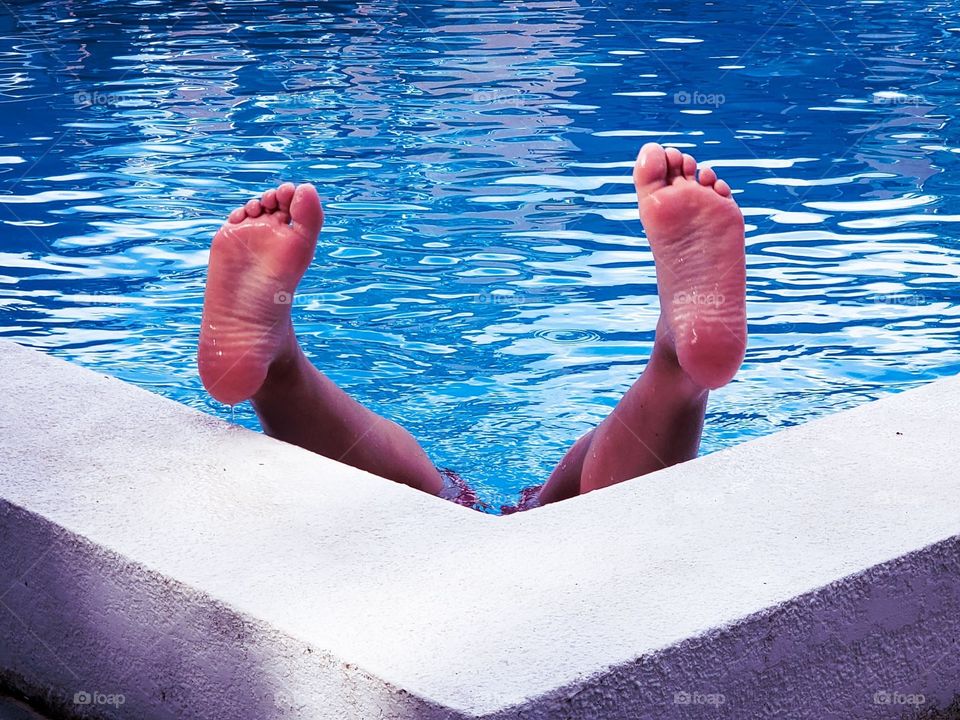 Boys feet in the pool