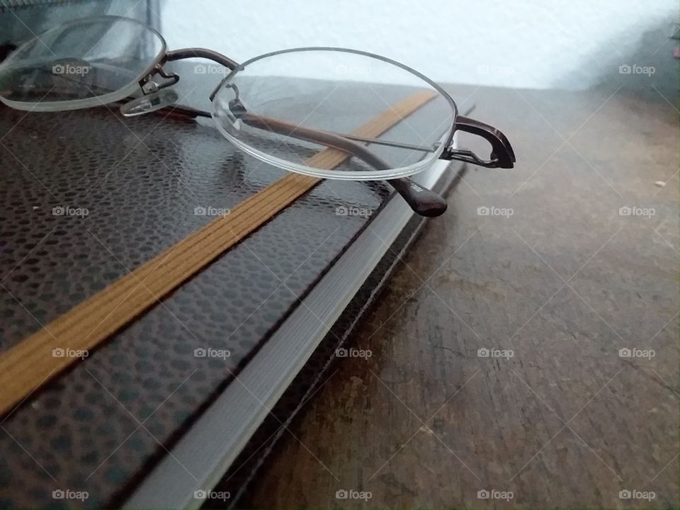 glasses and book on antique desk