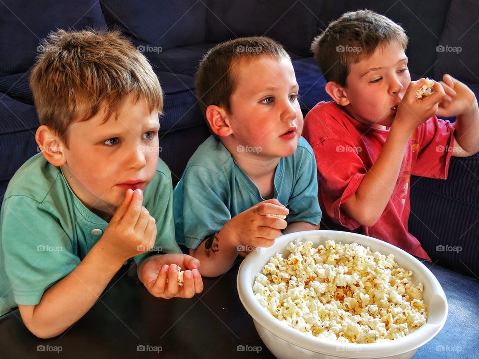 Kids watching a movie with popcorn