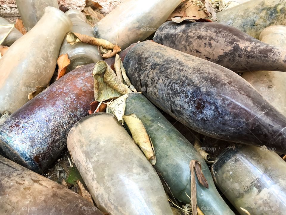 Antique and vintage bottles, variety, muddy and dirty, broken and intact, milk bottles medicine bottles, collectibles, background image