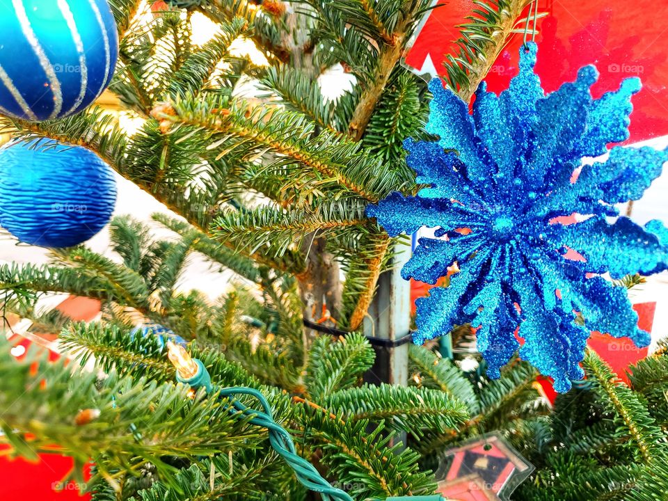 Christmas tree and blue ornaments close up