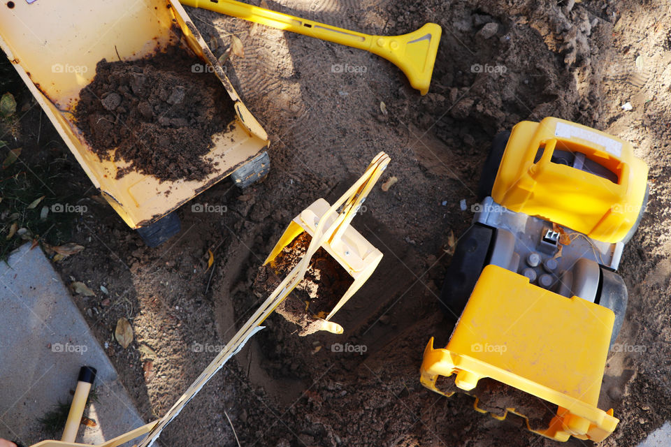 Yellow trucks and diggers in the sandbox