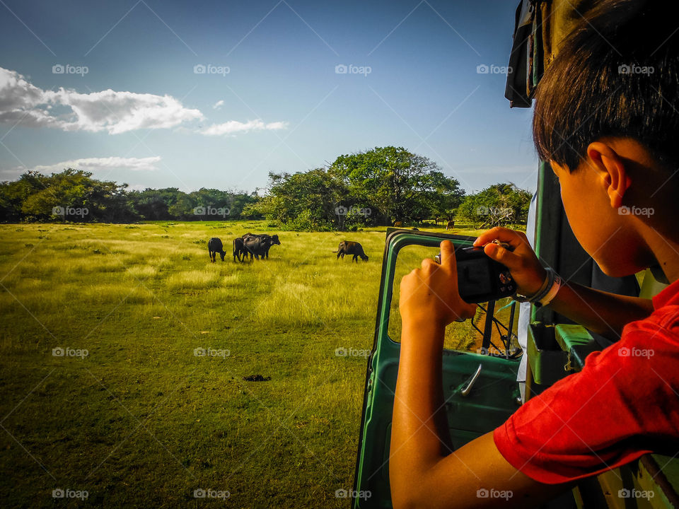 Boy is taking a picture on a trip