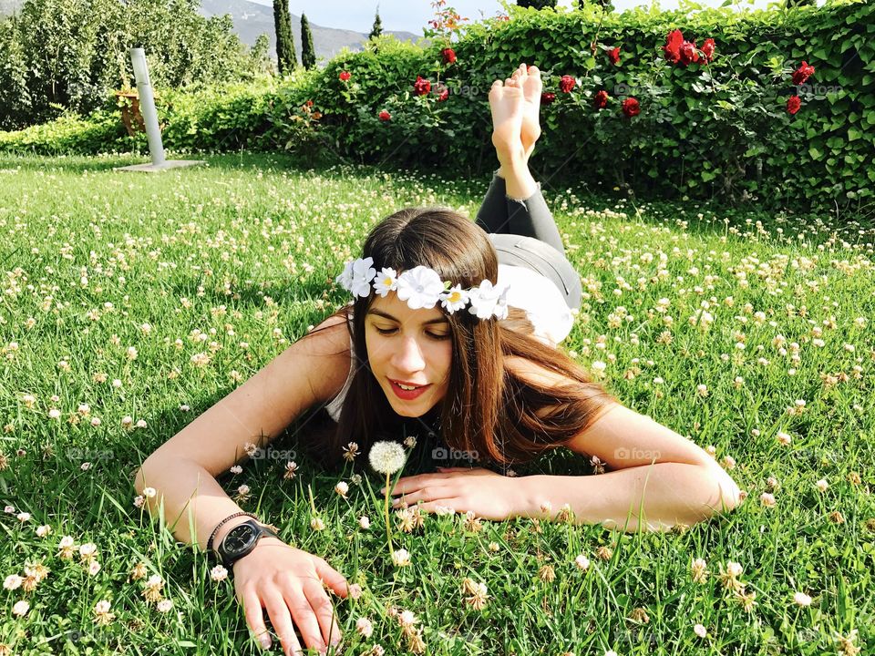 Beautiful woman lying on grass and looking down