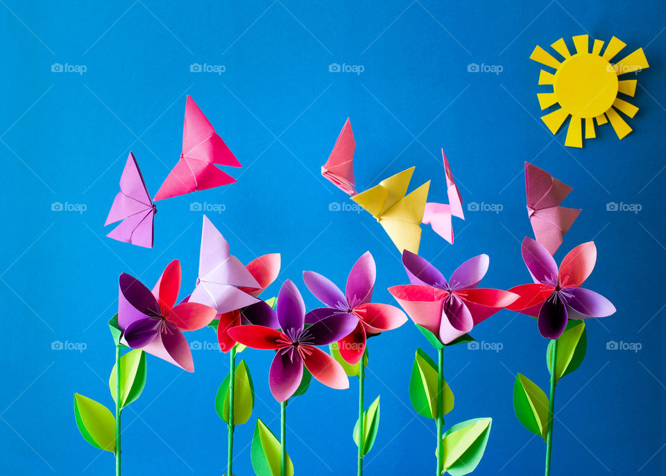 Paper craft. Colorful flowers with butterflies