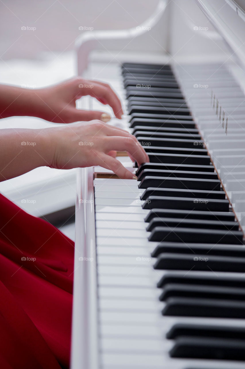 Delicatw and skilled hands working on a piano. Concentrated.