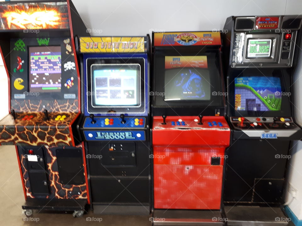 4 retro arcade video game consoles at The Centre for Computing History. The original sonic on the far right machine, Street Fighter 2 on the machine to the right of it, and the 2 left machines are collections of retro video games.