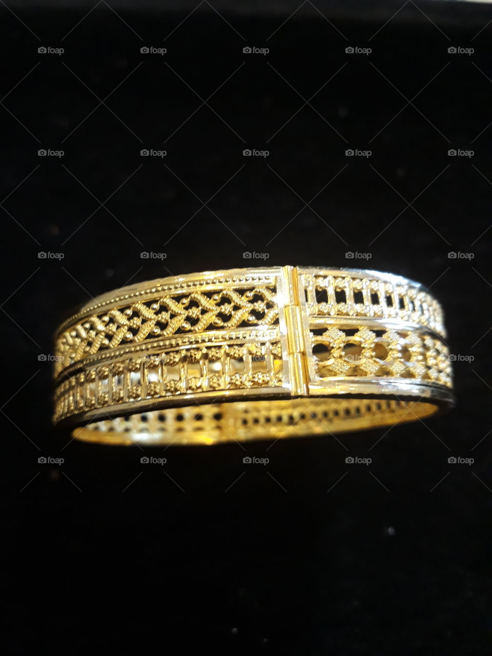 Gold bangle with small lock