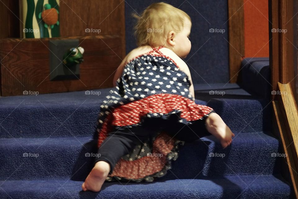 Toddler Girl Learning To Climb Stairs