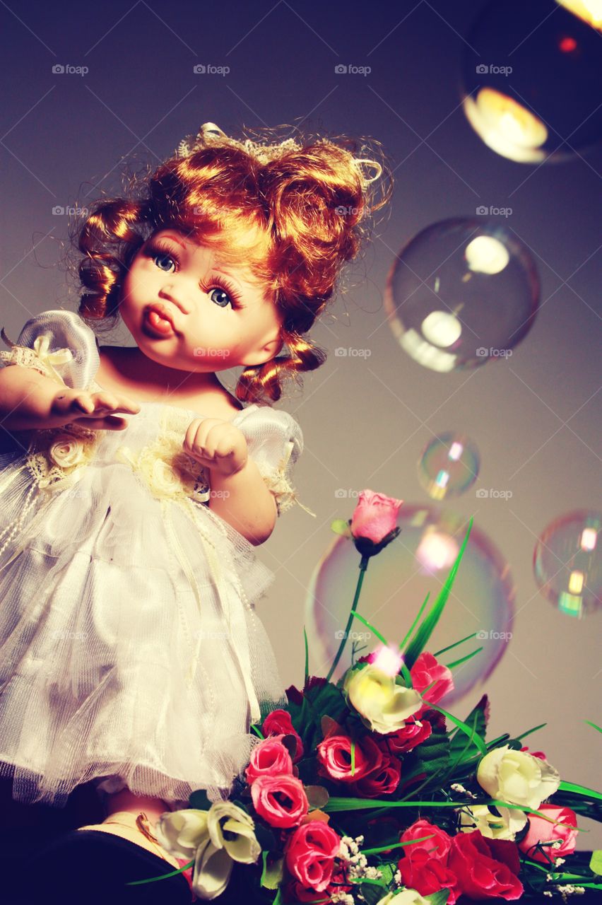 doll with flowers and soap bubbles