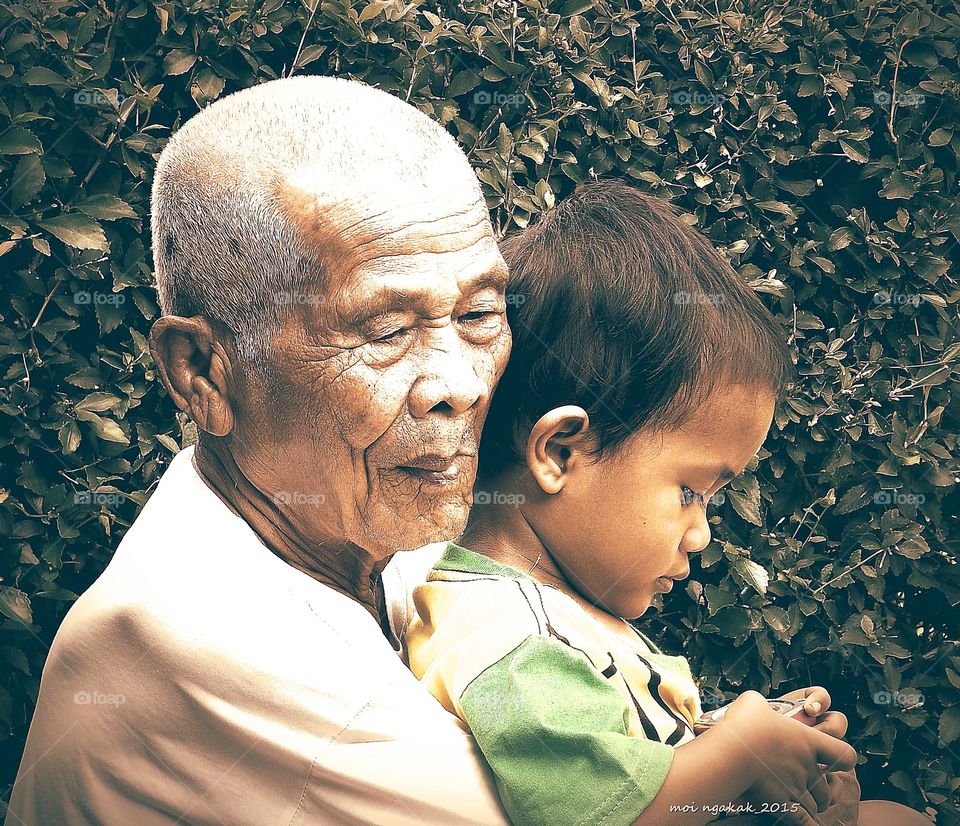 Senior man with grandson holding toy