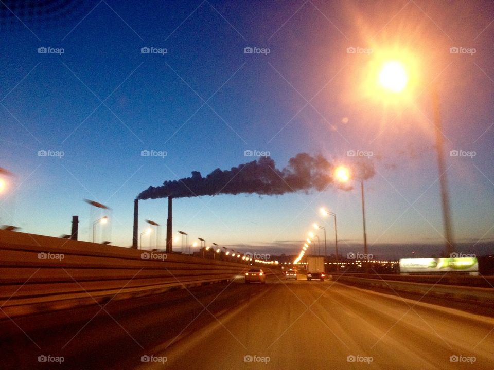 Chimneys smoke over evening sky