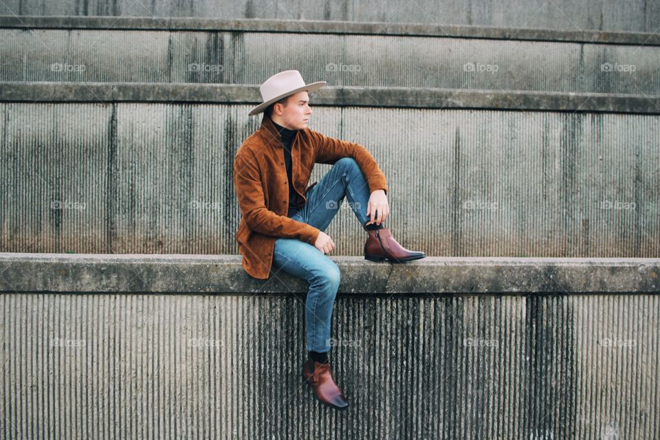 Thoughtful contrast at it’s finest, the soft portrait of a man against weathered concrete 