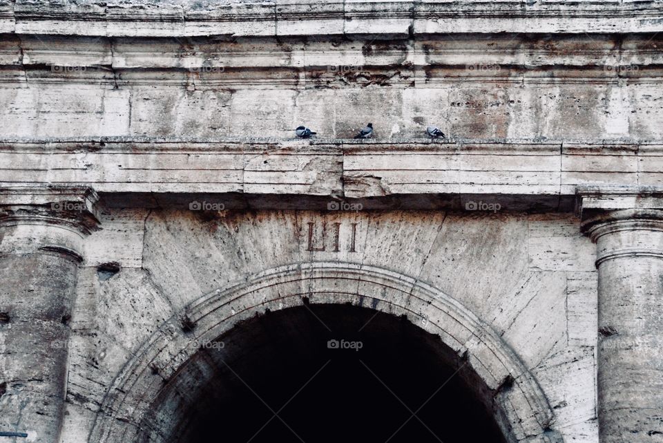 One of the arched entrances into the colosseum in Rome, Italy 