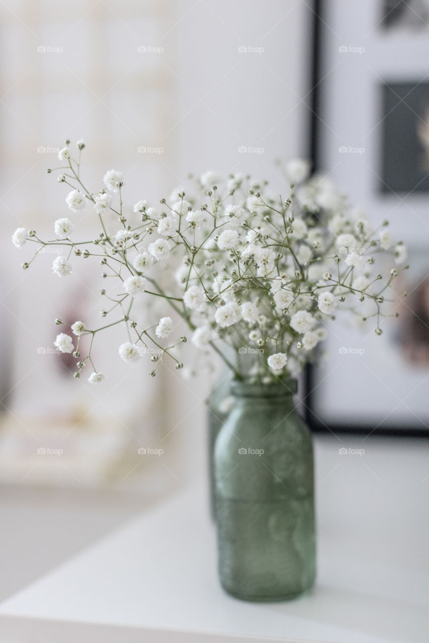 White flowers in a green vase. Light and airy