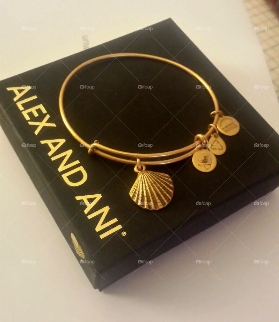 Alex and Ani bangle bracelet. gold Alex and Ani bangle bracelet with seashell charm